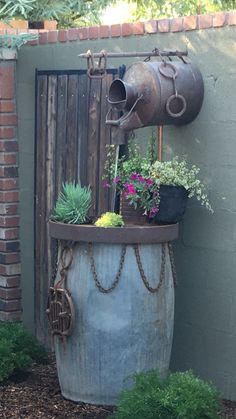 a potted plant sitting on top of a metal barrel