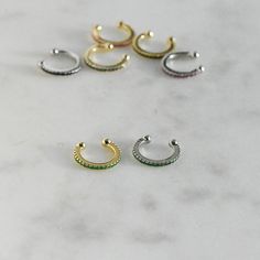 Dainty and minimalist ear cuff will add a sweet touch of chic and edge to your look! Easy to put on, and makes a maximum impact! Details ♦︎ 14k Gold or Rhodium plated over 925 Sterling Silver ♦︎ We use a thick plating for a piece that will be with you for years to come ♦︎ Sold as a Single Ear Cuff ♦︎ Adjustable Fit ♦︎ All stones made of highest quality cubic zirconia for authentic diamond look! Made with 100% Pure Love ♥︎ Earrings on Model can be found here: Tear Drop Charm Huggies: https://www. Minimalist Ear Cuff, Opal Stacking Ring, Baguette Earring, Sterling Silver Opal Ring, Black Diamond Earrings, Silver Opal Ring, Gold Link Bracelet, Fake Piercing, Opal Ring Gold