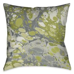 a green and white pillow with an abstract design on the front, in shades of gray