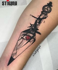 a black and white tattoo on the leg of a person with a knife in it