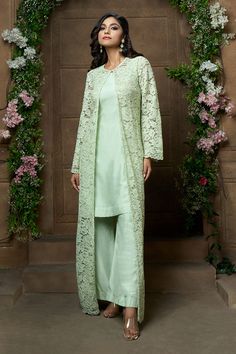 Pista green full sleeve jacket with floral lace and cutdana embroidery. Paired with solid sleeveless kurta and flared pant.
Components: 3
Pattern: Embroidery
Type Of Work: Floral, lace, cutdana
Neckline: Round
Sleeve Type: Cape: Bell sleeves, Kurta: Sleeveless
Fabric: Kurta and Pant: Bamberg Silk, Jacket: Santleen Net
Color: Green
Other Details: 
Scallop embroidered lace hem
Occasion: Destination Wedding - Aza Fashions Salwar With Jacket, Net Kurta Designs For Women, Co Ords Outfits Indian, Latest Kurti Designs Pattern, Kurti With Jacket, Cutdana Embroidery, Sleeveless Kurta, Velvet Embroidery, Lace Suit