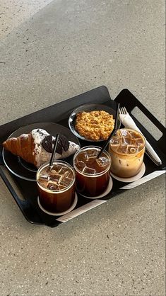 a tray with desserts and drinks on it