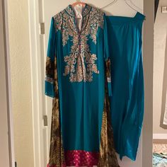 This Dress Has Multiple Color Like Blue Green Pink Brown It’s Nice And Soft .This Dress Is One Of Silkthreads Designer Collection. Elegant Turquoise Dress For Festive Occasions, Elegant Turquoise Festive Dress, Fitted Turquoise Dress For Festive Occasions, Festive Blue V-neck Dress, Turquoise Long Sleeve Festive Dress, Festive Turquoise Long Sleeve Dress, New Pakistani Dresses, Pakistani Fancy Dresses, Pakistani Dress