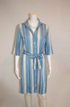 "Cotton shirtdress by John of California in stripes of blues, lavender, and off white.  Loose belt Mother of pearl buttons Size: no tag Measures laying flat: 18.5\" armpit to armpit, 18.5\" waist, 38\" shoulder to hem Condition: Good Vintage Condition" Spring Striped Belted Dress, Striped Belted Dress For Spring, Striped Collar Dress For A Day Out In Spring, Spring Day Out Dress With Striped Collar, Striped Belted Dresses For Daywear, Elegant Striped Belted Dress, Spring Dresses With Striped Collar For Day Out, Button-up Shirt Dress With Striped Collar For Daywear, Spring Striped Collared Shirt Dress