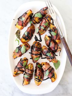 a white plate topped with grilled vegetables next to a fork