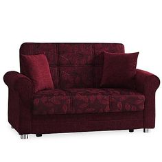 a red couch with two pillows on it