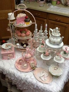 a table topped with lots of cakes and cupcakes