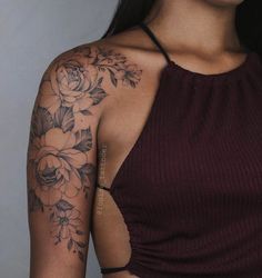 a woman with tattoos on her arm and shoulder