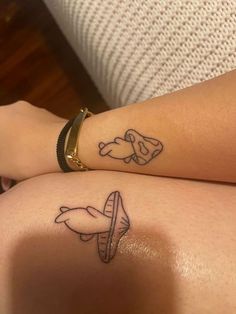 two people with matching tattoos on their arms