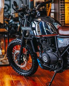 the motorcycle is parked on the wooden floor