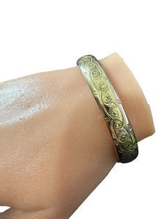 Beautifully etched floral 1890s hinged bangle bracelet. The bracelet is 12k gold filled with an ornate etched pattern around the circumference of the bracelet. The bracelet is fitted with a hidden clasp and safety clasp. ERA - Circa 1890s METAL / MATERIAL - 12k gold filled  MARKINGS / HISTORY - N/A CONDITION - Good vintage condition. Gold filled metal has been polished & cleaned. Age appropriate patina & wear remains. Amazing vintage bangle bracelet! MEASUREMENTS - Inner circumference: 7 inches, Luxury Engraved Victorian Cuff Bracelet, Luxury Antique Engraved Cuff Bracelet, Bracelet Measurements, Vintage Bangle Bracelets, Vintage Bangles, Hinged Bangle, Victorian Era, Statement Jewelry, Floral Motif