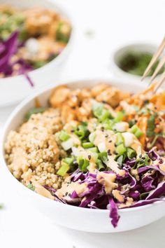 two bowls filled with food and chopsticks sticking out of the top one bowl