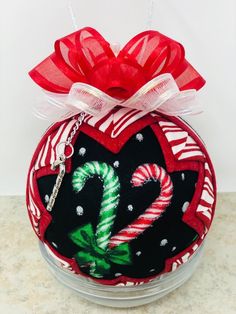 a christmas ornament with candy canes on it