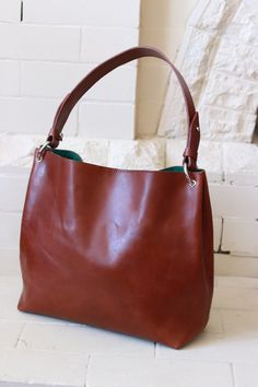 Grace hobo bag is made of the vegetable tanned Buttero leather from Conceria Walpier tannery in Italy. The color in the pictures is Walnut. Height: 11.00" (27.5cm) Width: 11.50" (about 29cm) Base: 11.5 x 4.5" (11.25cm) Strap drop 8.5"  (21.25cm) Originally the bag has a magnet closure, the zip closure is also available, it'll look like 2 leather strips about 1.5" width with smooth metal zipper between them and "sunk" in the bag. Weight: about 21-24oz (about 600-700gr)  depending on the fabric you'll pick for the lining and how many pockets the bag will have. The bag is on made to order basis, please let me know if you need your bag to a certain day. You'll get the pictures of the finished bag before shipping to make sure everything is great. Pockets Inside:  raw of 3 slide pockets and/or 1 Leather Bucket Hobo Bag With Smooth Grain, Leather Hobo Bag With Smooth Grain In Bucket Shape, Everyday Saddle Shoulder Bag With Smooth Grain, Cognac Hobo Bag With Smooth Grain For Everyday, Brown Satchel Hobo Bag With Handle Drop, Brown Leather Hobo Bag With Leather Lining, Brown Leather Hobo Satchel Bag, Brown Leather Shoulder Hobo Bag, Brown Leather Satchel Hobo Bag