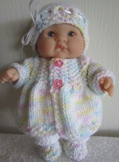 a small baby doll wearing a knitted outfit