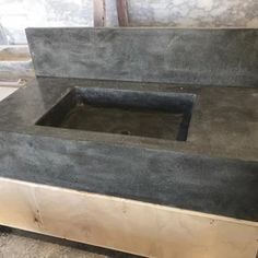 a black counter top sitting inside of a room next to a wall and flooring