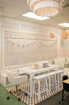 a white table and chairs in front of a wall with writing on it that says home sweet classroom