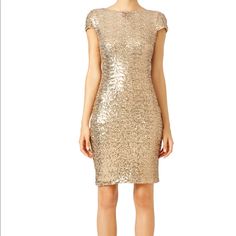 a woman wearing a gold sequin dress