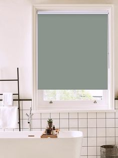 a white bath tub sitting next to a window