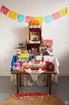 a table that has some food on it and decorations hanging from the wall behind it