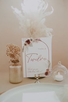 a table with a card and some flowers on it