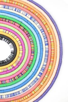 a circular arrangement of multicolored paper strips arranged in a circle on top of each other