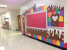 an empty hallway with decorated walls and flooring in the school's cafeteria area