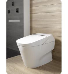 a white toilet sitting on top of a wooden floor