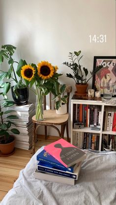 a bedroom with sunflowers and books on the bed