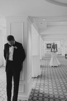 a man in a tuxedo standing next to a woman in a wedding dress