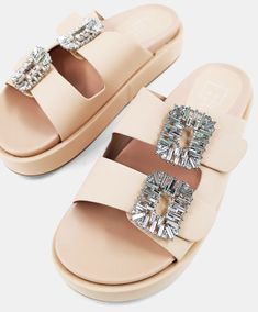 Our stunning LOLA flatform sandals are crafted meticulously from the highest quality soft faux leather that will comfortably mold to your feet. They feature two buckle ornaments embellished with crystals, adding an extra touch of elegance and style. The pair is designed to provide both comfort and style throughout the day, with a wedge platform offering the perfect combination of cushioning and support. Perfect for any outfit, with their exquisite design and luxurious feel. Make sure to pack them for your next weekend getaway! Flatform Sandals, Weekend Getaway, Platform Wedges, Exquisite Design, Sale Items, Wedges, Faux Leather, Buckle, Sandals