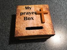 a wooden box with a cross on it and the words my prayer box written in black