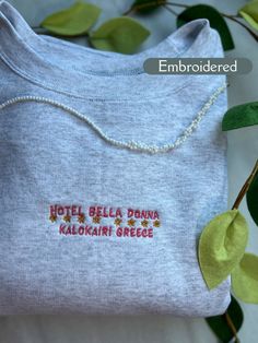 *Hotel Bella Donna Kalokairi Greece embroidered sweatshirt! This would make the perfect unique gift to treat yourself or a great gift for friends and family!  *This design is embroidered on the Ash colored crewneck shown in the product photos, but is available in other colors.  -Machine embroidered with high quality thread that gives this crewneck a vintage look! This sweatshirt will keep you warm and cozy as well as stylish!  ✰This item is MADE TO ORDER and can take 2-4 Weeks to be processed an Long Sleeve T-shirt With Machine Embroidery As Gift, Custom Embroidered Long Sleeve T-shirt, White Embroidered Sweatshirt As Gift, White Embroidered Sweatshirt For Gift, Multicolor Embroidered Text Crew Neck Sweatshirt, Multicolor Embroidered Logo Sweatshirt Crew Neck, Embroidered Relax Fit Sweatshirt For Gift, Embroidered Relaxed Fit Sweatshirt As Gift, Embroidered Relaxed Fit Sweatshirt For Gift