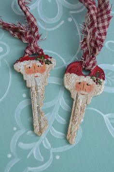 two christmas themed keys are hanging on a wall