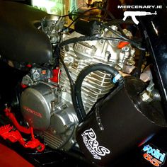 the engine of a motorcycle is shown in close up with stickers on its side