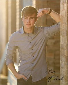 a young man is posing for a photo