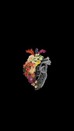 a heart made out of flowers on a black background