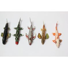 five different types of fish on a white surface