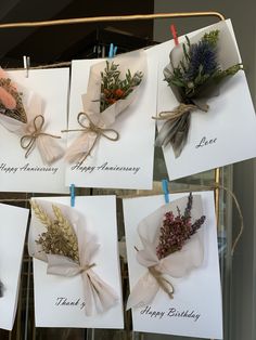 five greeting cards with flowers tied to them