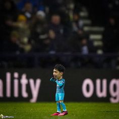 a young man standing on top of a soccer field