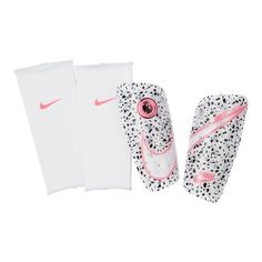 a pair of white and pink tennis shins next to each other on a white background