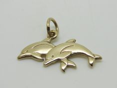 This beautiful charm is an authentic James Avery piece in yellow gold stamped with the candle sticks 14K ©. The charm is called Twin Dolphins and it is a retired piece and a very rare find. The charm measures 1" in length and the jump ring is cut. The charm does not come in its original packaging. RING SIZE: N/A TOTAL WEIGHT: 2.3 Grams CONDITION: Excellent REF. CODE: LB3416 Feel free to Visit My ebay Store and browse through my other items for some more unique fine jewelry and collectibles. All Elegant 14k Gold Charms For Collectors, Elegant 14k Gold Collectible Charms, Classic Sterling Silver Charms, Classic Gold Sterling Silver Charms, Classic Gold-colored Sterling Silver Charms, Symbolic Yellow Gold Charms For Gift, Classic Yellow Gold Charms For Gifts, Classic Yellow Gold Charms For Gift, Classic Gold Charms For Gifts