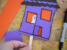 someone is making a house out of construction paper