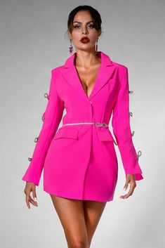 a woman in a bright pink suit and high heels is posing for the camera with her hands on her hips