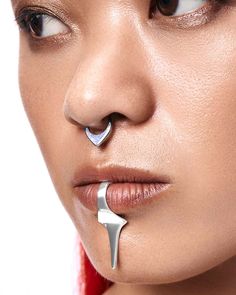 a woman with nose piercings on her nose