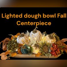 a sign that says lighted dough bowl fall centerpiece with pumpkins and gourds