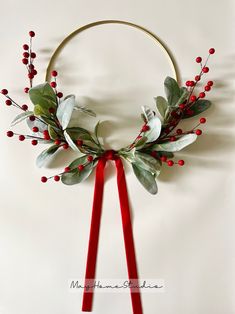 a wreath with red berries and green leaves