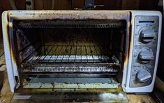 an old toaster oven sitting on top of a wooden table