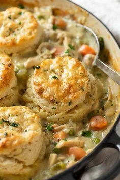 chicken pot pie with biscuits and vegetables in a skillet