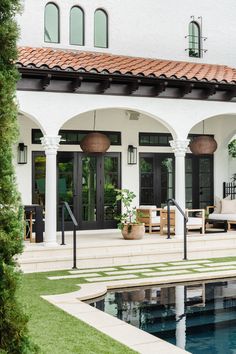 an advertisement for a house with a pool in the foreground and patio furniture on the other side